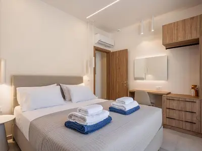 a bedroom with a bed with towels on it at Aurea Beach Villa in Kato Daratso