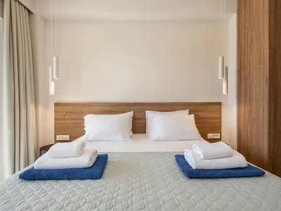 a bedroom with a bed with two towels on it at Aurea Beach Villa in Kato Daratso