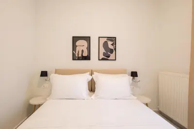 a bedroom with a white bed with two white pillows at Apanemia Apartment in Chania Town