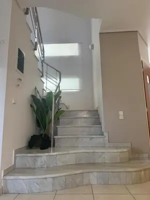 a staircase in a building with a stair case at Casa Ansia Luxury Living 50m from the Beach in Stalos