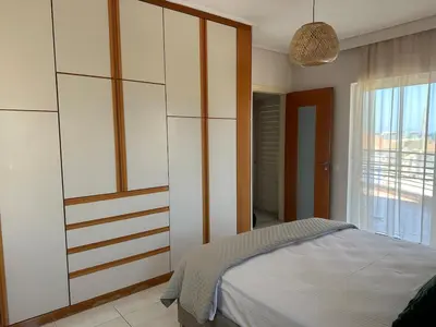 a bedroom with a bed and a large window at Casa Ansia Luxury Living 50m from the Beach in Stalos