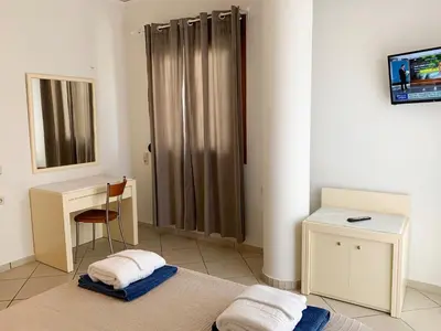 a bathroom with a shower with a desk and a table at Platanias Memories Studio 3 in Plataniás