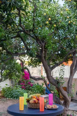 a picnic table with a basket of fruit and candles at Lemon Tree Chania in Chania Town