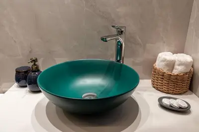 a green bowl sink on a counter in a bathroom at Lemon Tree Chania in Chania Town