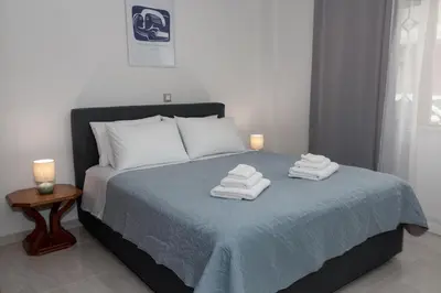 a bedroom with a bed with towels on it at Lemon Tree Chania in Chania Town