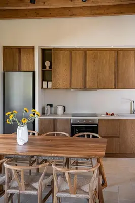 a kitchen with a wooden table and chairs at Armenaki Residence in Arménoi