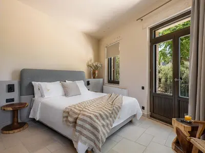 a bedroom with a large bed and a window at Armenaki Residence in Arménoi