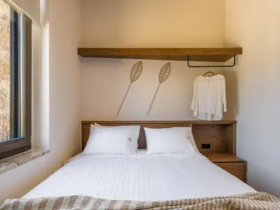 a bedroom with a bed with white sheets at Armenaki Residence in Arménoi