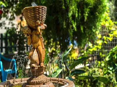 a statue of a woman sitting on top of a fountain at Holiday home, Marathokefala near Kolimbari in Marathokefála