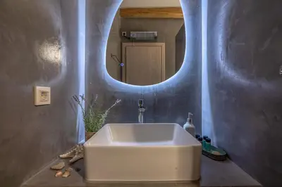 a bathroom with a white sink and a mirror at Villa Alma Libre Kissamos in Kissamos