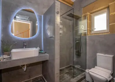 a bathroom with a sink and a toilet and a mirror at Villa Alma Libre Kissamos in Kissamos