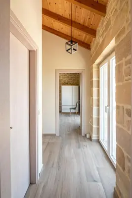 an empty hallway with wood floors and a brick wall at Villa Alma Libre Kissamos in Kissamos