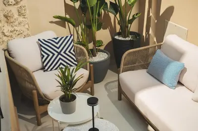 a living room with two chairs and potted plants at Old Town Apt, Balcony, brand new, family, central in Chania Town