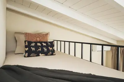 a room with a bed with a pillow on a balcony at Old Town Apt, Balcony, brand new, family, central in Chania Town