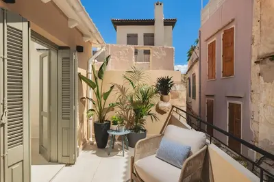 a balcony with a couch and potted plants at Old Town Apt, Balcony, brand new, family, central in Chania Town