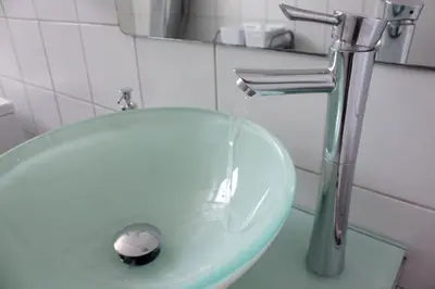 a bathroom sink with water coming out of a faucet at Fifty Shades of Blue 10 sec to sea 5PL 2BD 2BA in Stalos