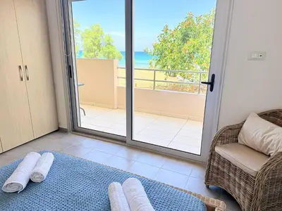 a living room with a view of the ocean at Fifty Shades of Blue 10 sec to sea 5PL 2BD 2BA in Stalos