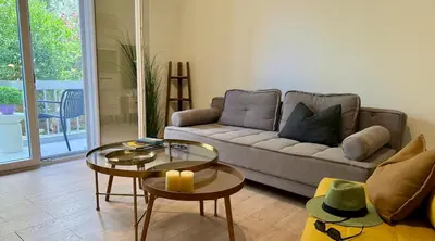 a living room with a couch and a table at Kalliso City Apartment near the beach in Chania Town