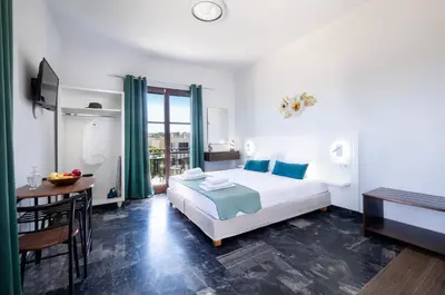 a bedroom with a bed and a table and a desk at Anastasia Veridian Living in Kalathas