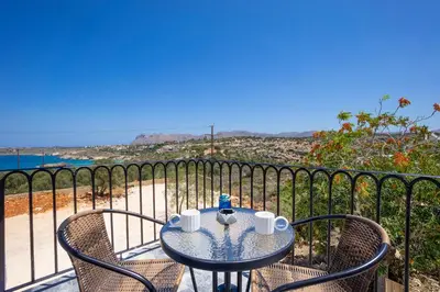 a table and chairs with a view of the beach at Anastasia Veridian Living in Kalathas