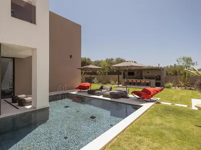 a house with a swimming pool next to a yard at Villa Azahar Serene Luxury Living in Milonianá