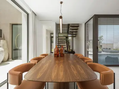a dining room with a wooden table and chairs at Villa Azahar Serene Luxury Living in Milonianá