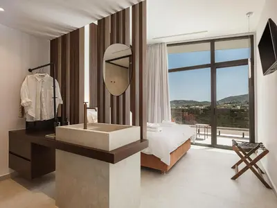 a large bathroom with a sink and a mirror at Villa Azahar Serene Luxury Living in Milonianá
