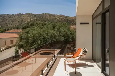 a balcony with chairs and a view of a mountain at Villa Azahar Serene Luxury Living in Milonianá