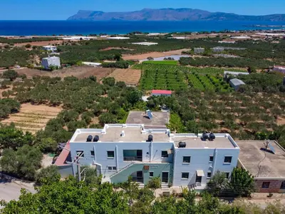 an aerial view of a house with the ocean in the background at Xenios Zeus Apartments in Kissamos