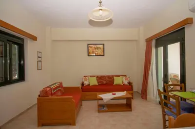 a living room with a couch and a table at Xenios Zeus Apartments in Kissamos