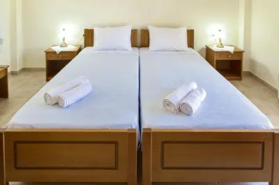 a large bed with two pillows on top of it at Xenios Zeus Apartments in Kissamos