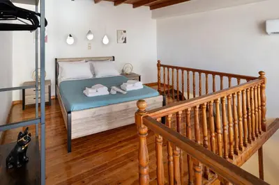 a bedroom with a bed and a staircase at Ariadne de Potie Maisonette in Chania Town