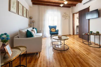 a living room with a couch and a table at Ariadne de Potie Maisonette in Chania Town