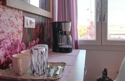 a kitchen counter with a blender on a table at Elpida's Gοds in Chania Town