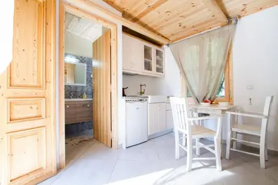 a kitchen with a table and chairs in a room at Mera Beachfront House - Falasarna in Falasarna