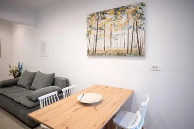 a living room with a wooden table and a couch at The Cozy Twins in Chania Town