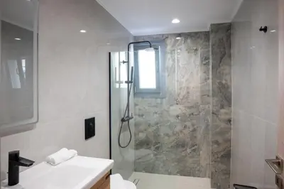 a bathroom with a shower and a sink at The Cozy Twins in Chania Town