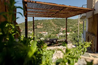 a picnic table under a roof with a view of a mountain at Cozy House Zoi -Top Views, On The Way To Elafonisi in Élos
