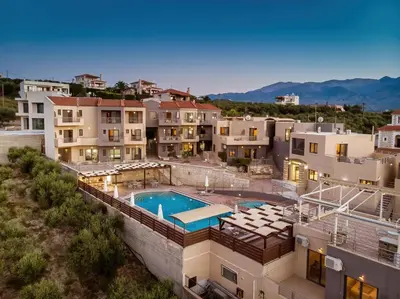 an aerial view of a building with a swimming pool at Sunrise Suites & Apartments in Kalyves