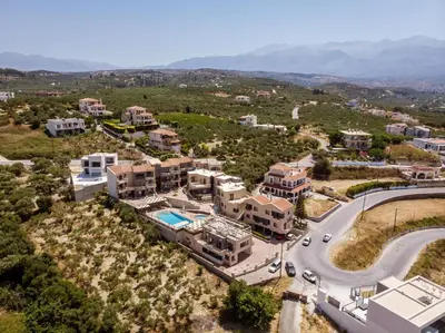 an aerial view of a house with a road at Sunrise Suites & Apartments in Kalyves