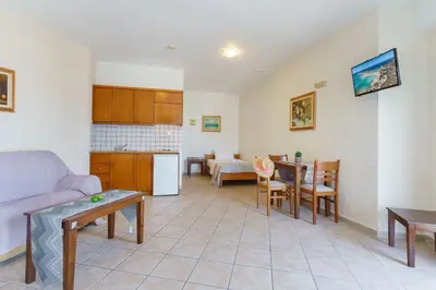 a living room with a couch and a table at Sunrise Suites & Apartments in Kalyves