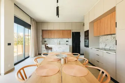 a kitchen with a wooden table and chairs at Madre Tierra Boutique Villas 1 & 2 in Liyidhés