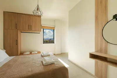 a bedroom with a bed with two towels on it at Madre Tierra Boutique Villas 1 & 2 in Liyidhés