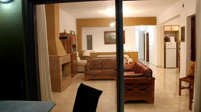 a living room with a couch and a bed in a room at Villa Sofia Filoxenia in Kalyves