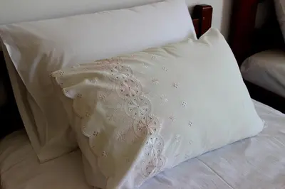 a white pillow sitting on top of a bed at Villa Sofia Filoxenia in Kalyves