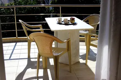 a white table and chairs on a balcony at Villa Sofia Filoxenia in Kalyves