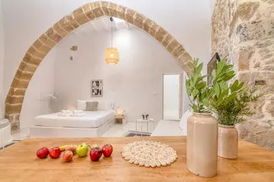 a living room with a table with fruit on it at The Mulberry Stonehouse Mountain - Sea View in Kalleryianá