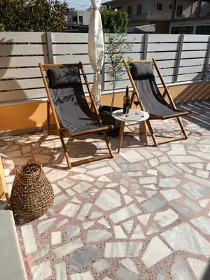two chairs and a table on a patio at Two little olives Studio apartment in Kissamos