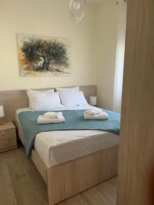 a bedroom with a bed with two towels on it at Two little olives Studio apartment in Kissamos