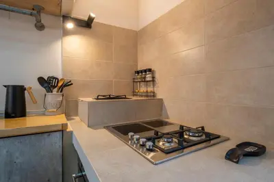 a kitchen with a stove and a counter top at Le Nid The Nest of Beauty in Chania Town